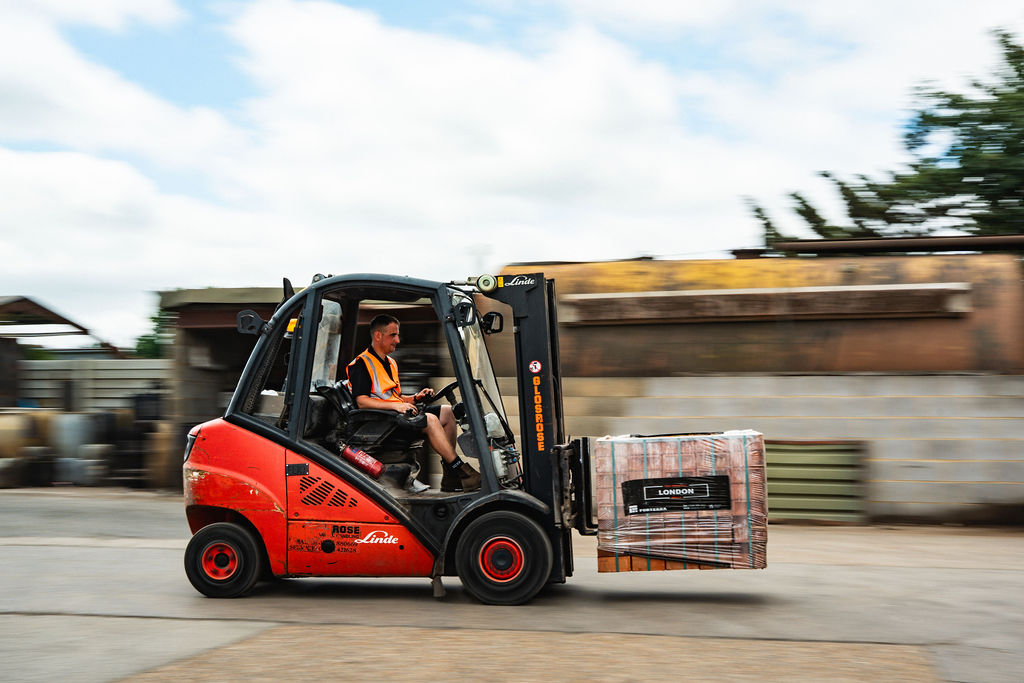 Forklift moving at speed across the yard