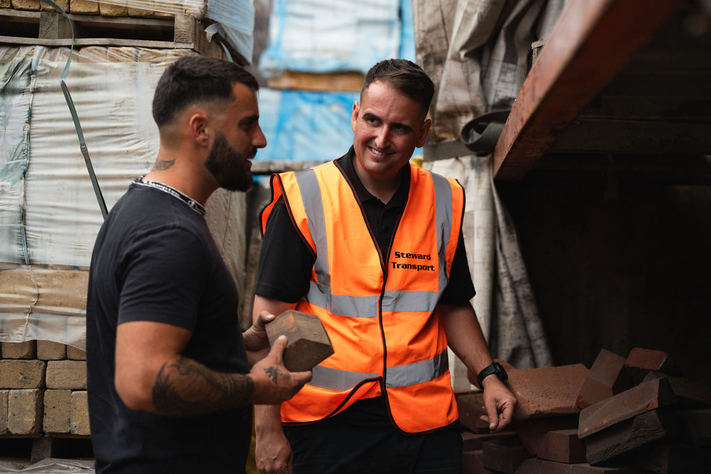 A member of the Steward team talking a customer through a brick