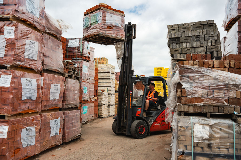Forklift stacking packs high in the yard